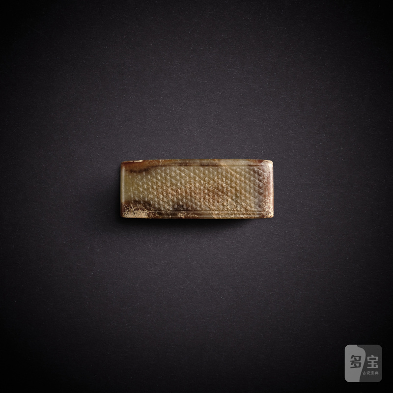A celadon and russet jade scabbard slide, Han dynasty | 漢 青玉劍璏